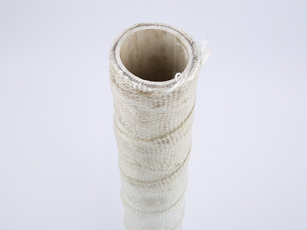 A white fire sleeve is placed vertically on a white table